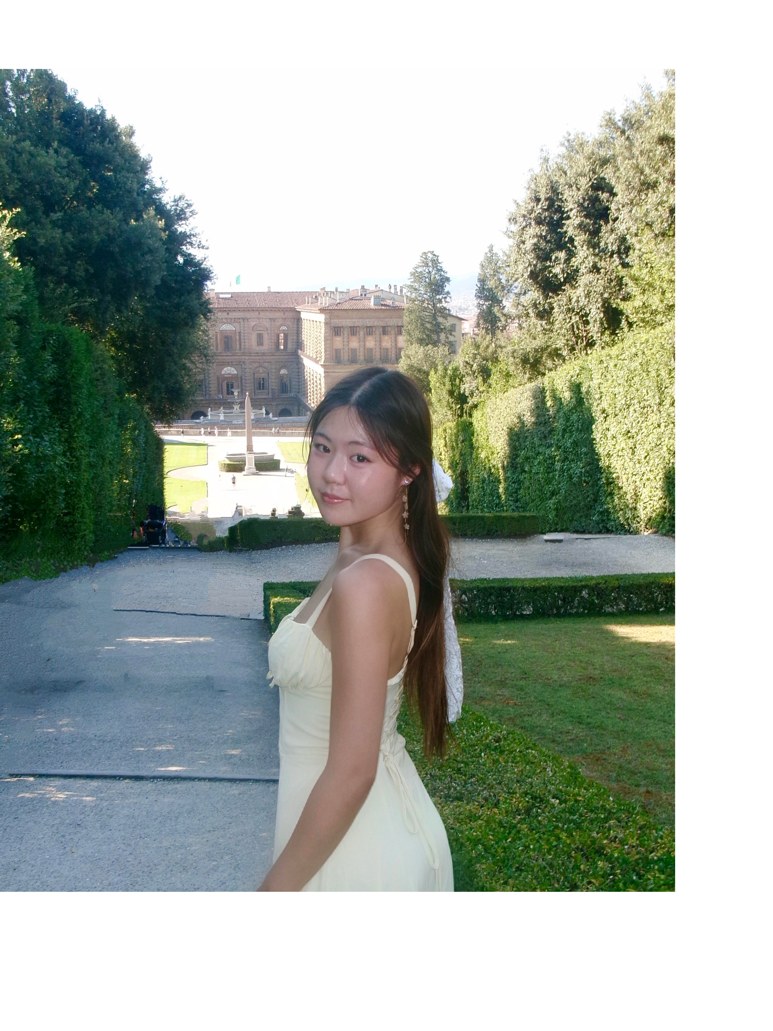 Picture of Allston Liu smiling in a yellow dress.