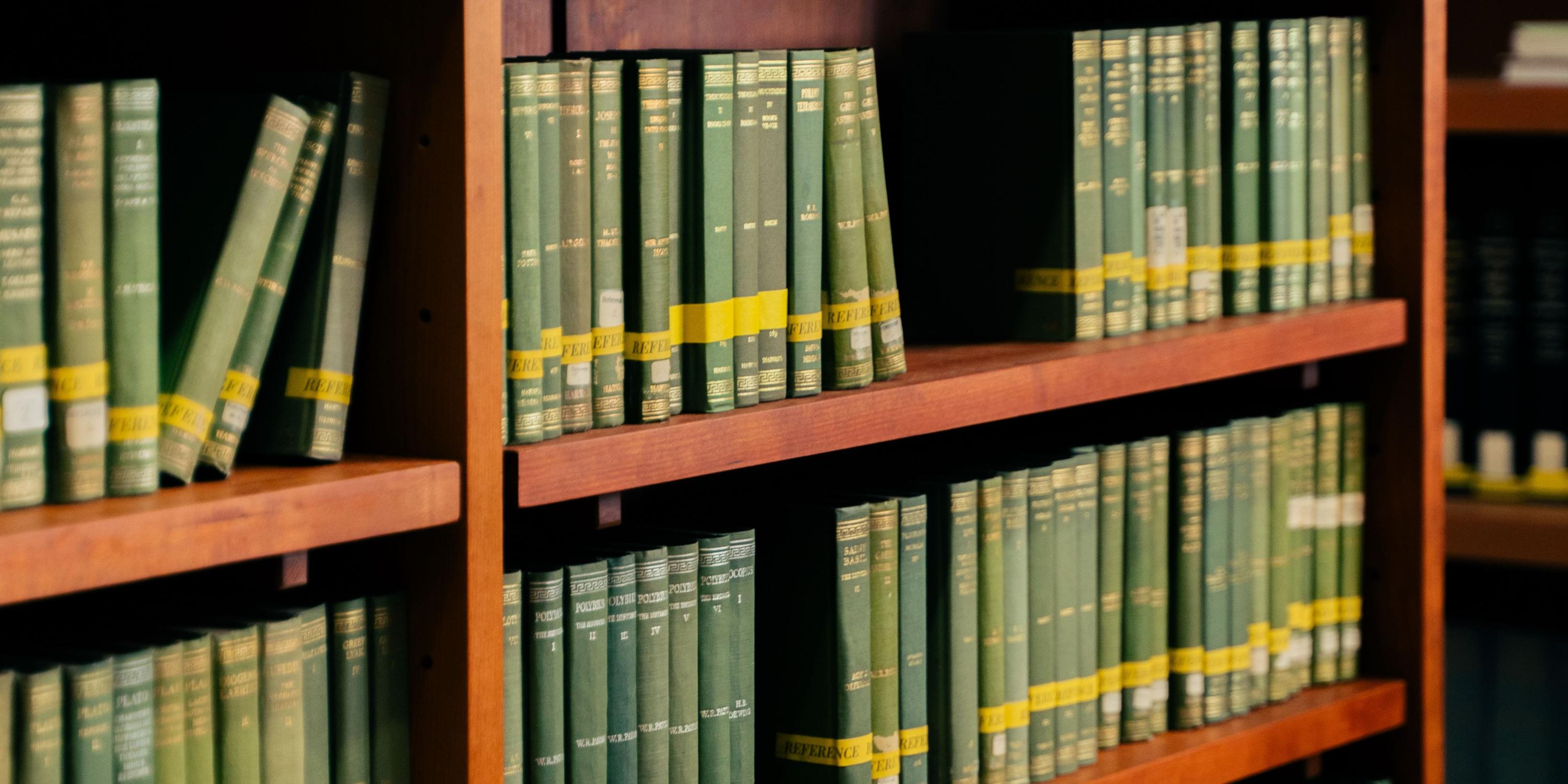 An image from a library showing a books arranges in neat rows in shelves