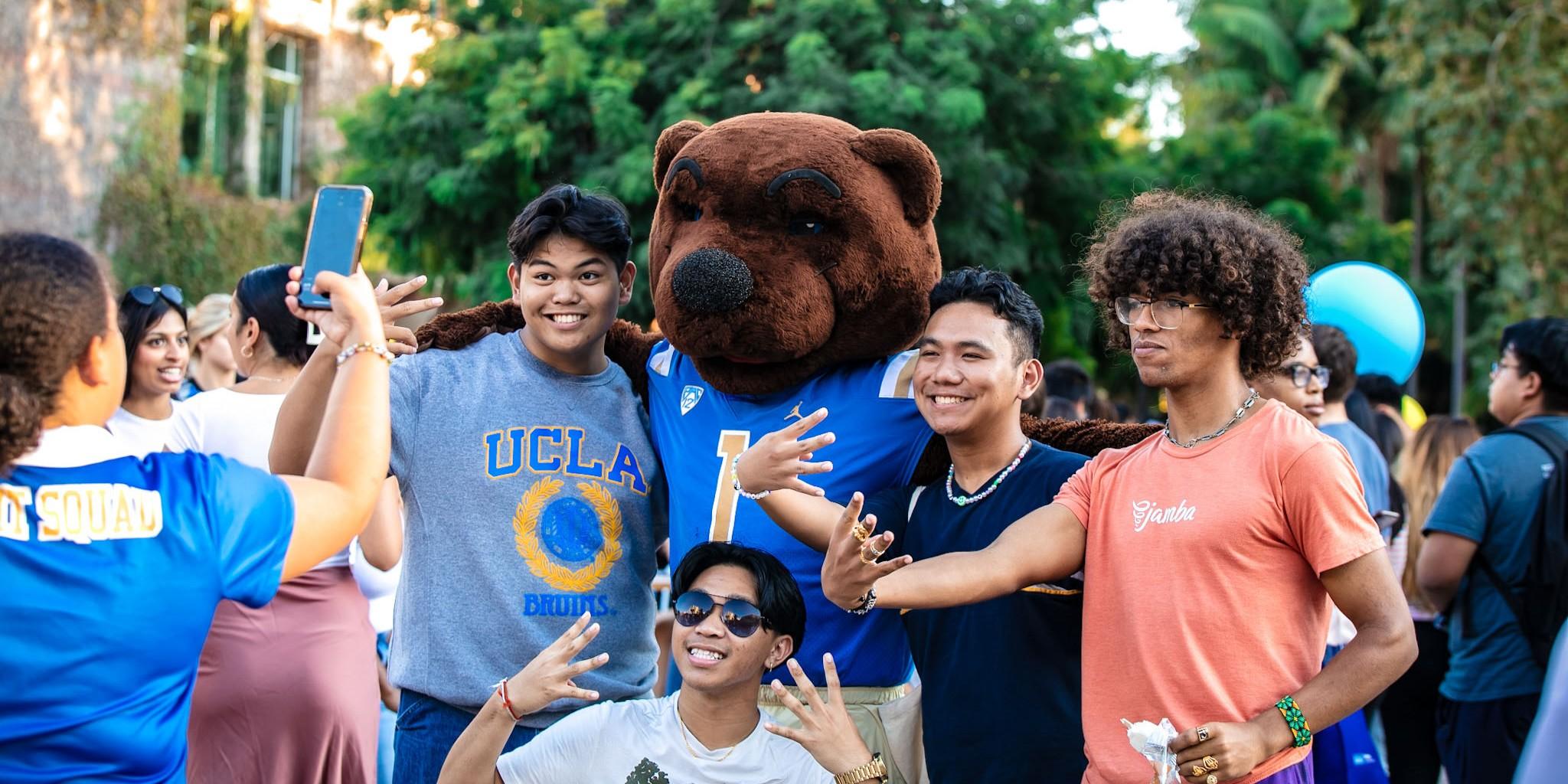 A group of students taking a photo with Joe Bruin