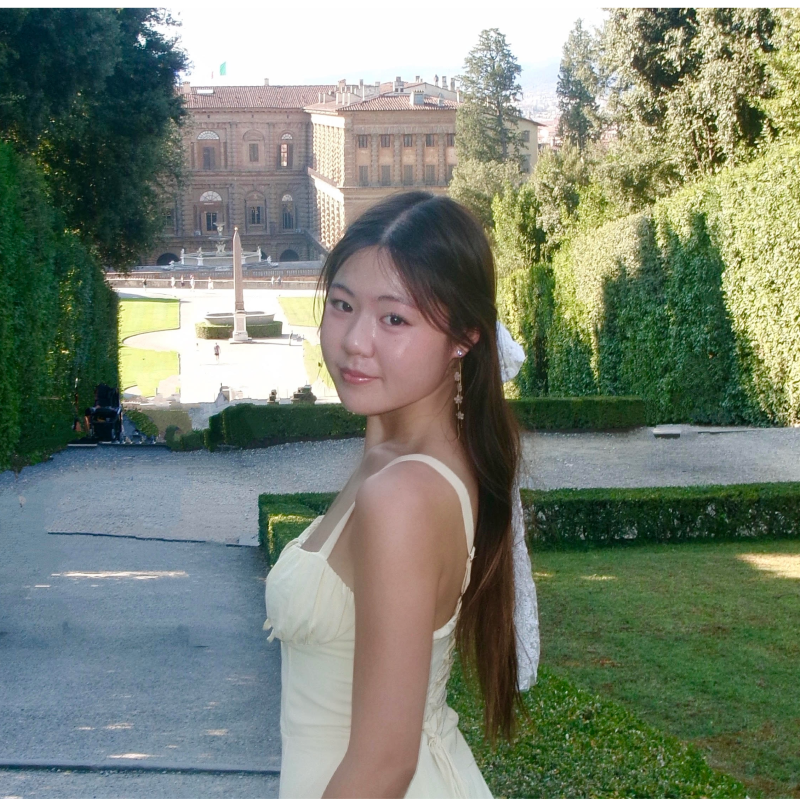 Picture of Allston Liu smiling in a yellow dress.