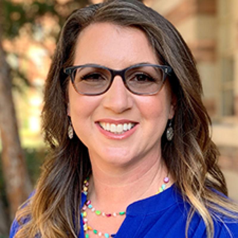 Picture of Karen Hedges smiling in a blue blouse.
